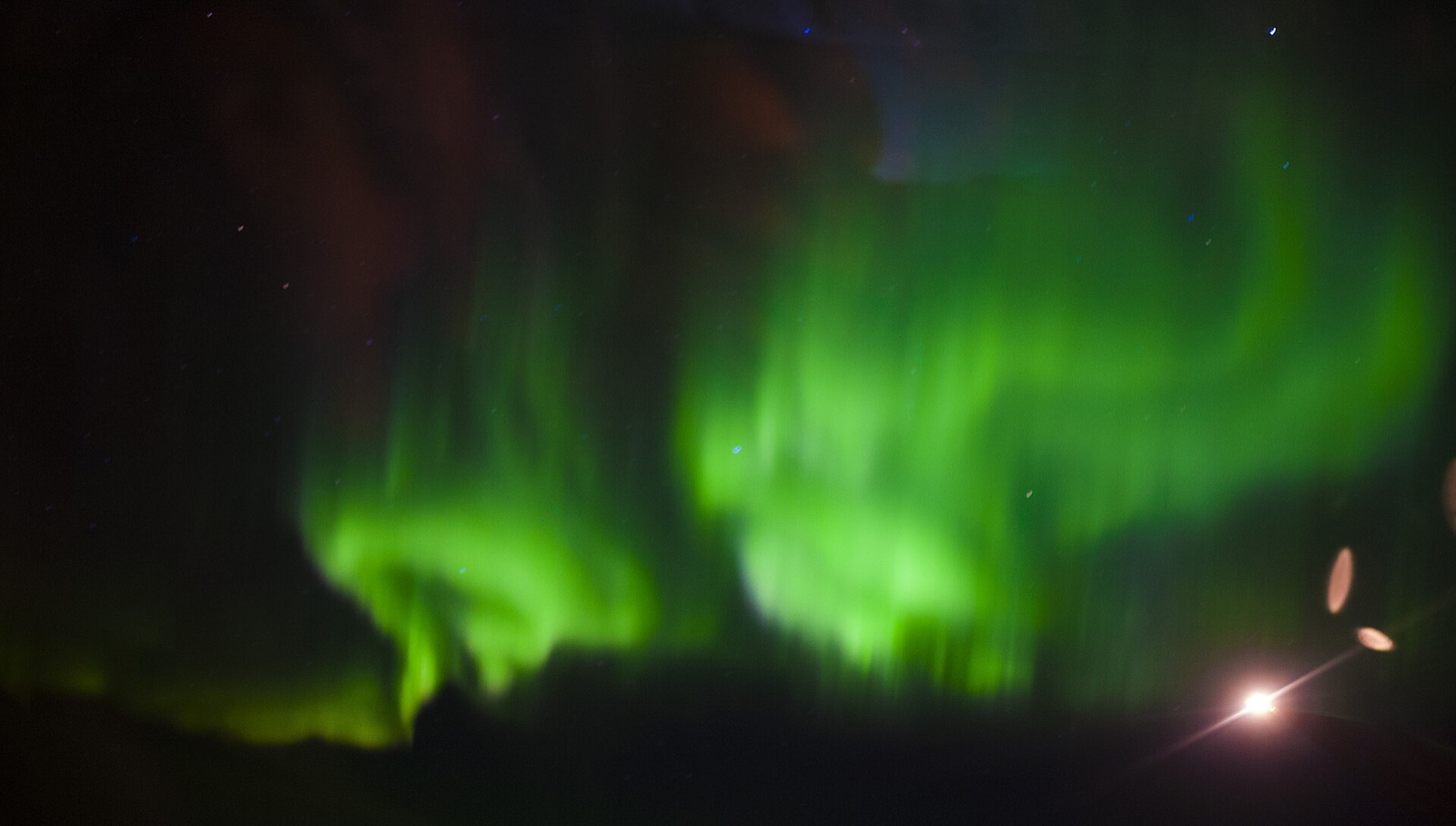 Green aurora borealis over Hudson Bay on a clear night