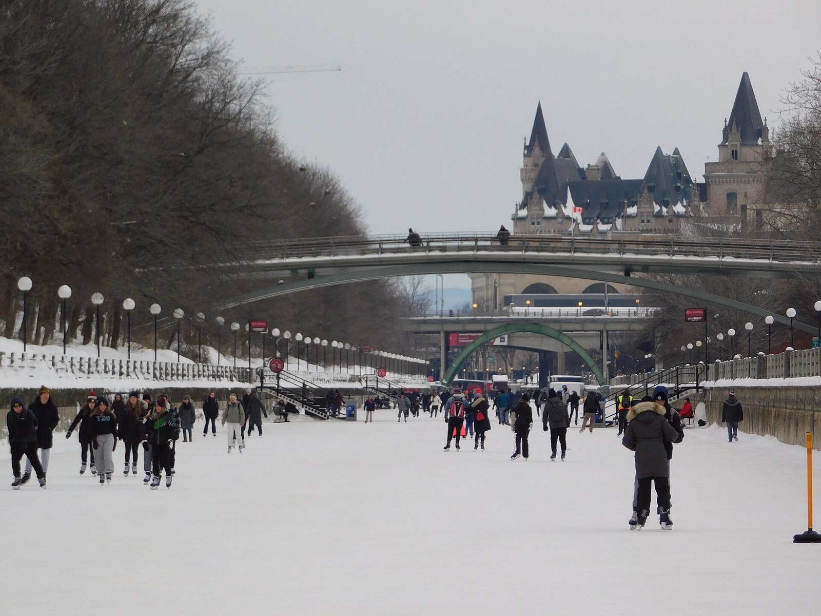 Skaters on the Rideau Canal Skateway in Ottawa, with the Chateau Laurier behind