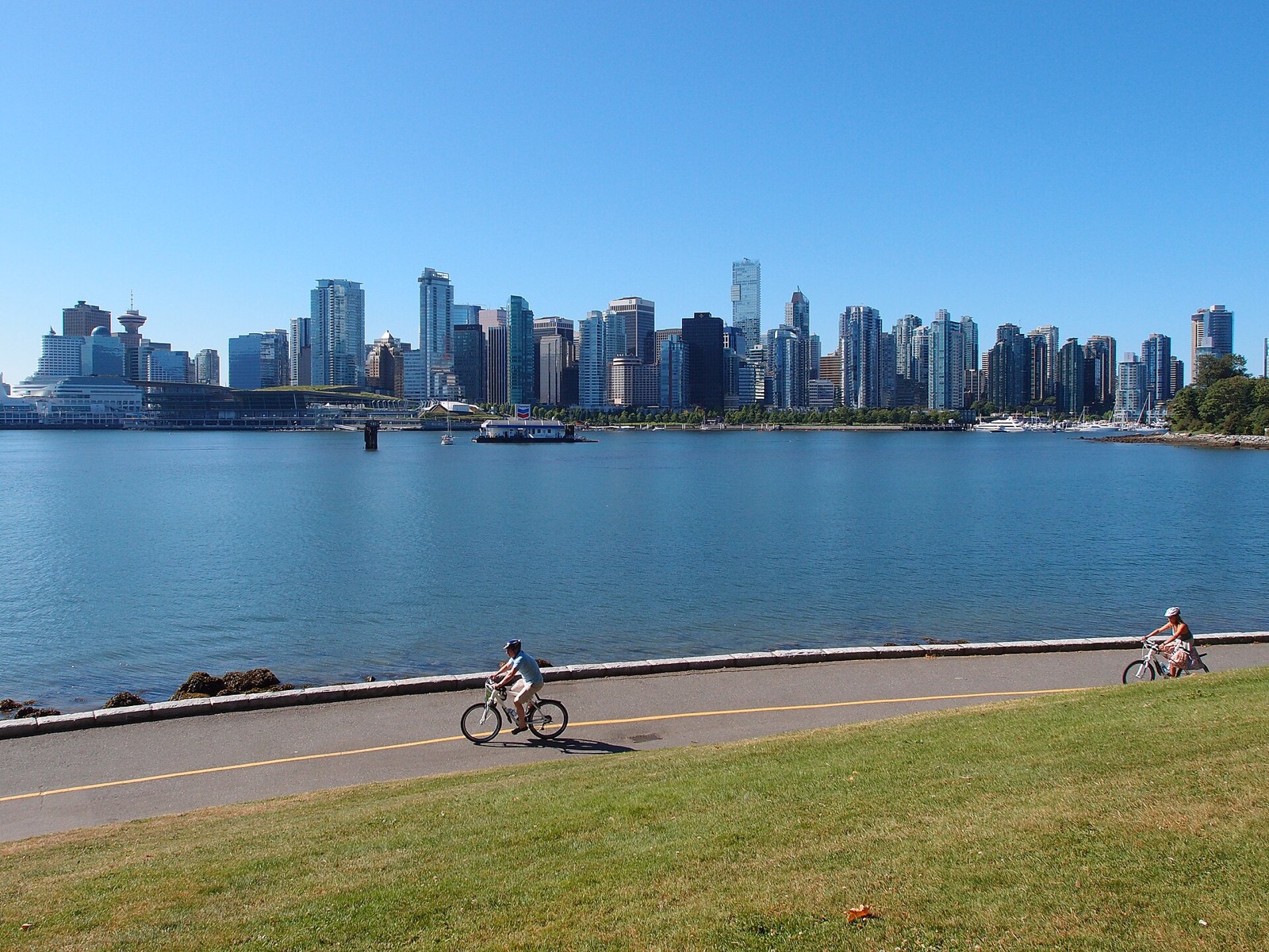 The Stanley Park seawall in Vancouver with the downtown skyline across the water