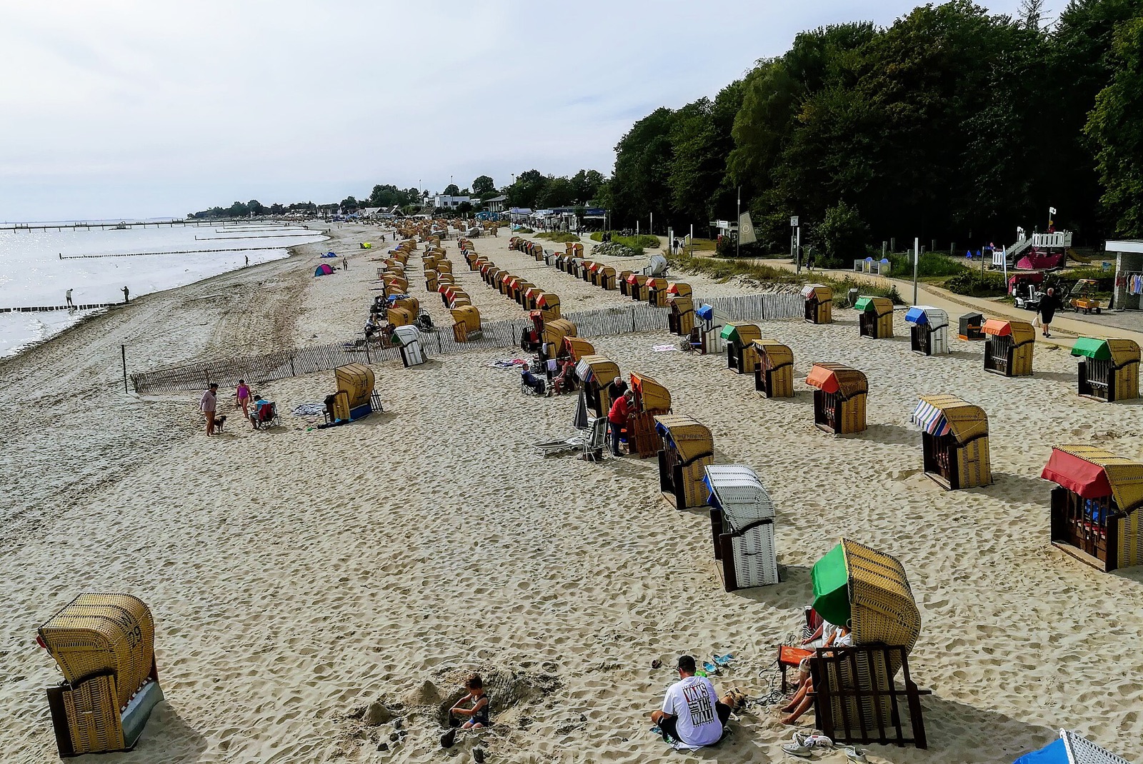 Rows of roofed wicker beach chairs on the sand at Kellenhusen on the German Baltic coast in summer