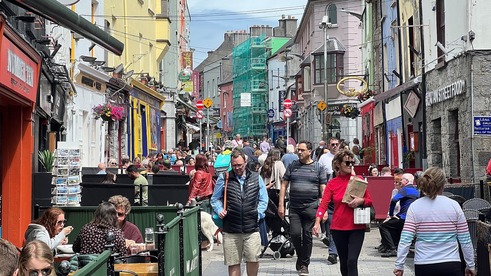 Quay Street in Galway crowded with people walking between painted shopfronts