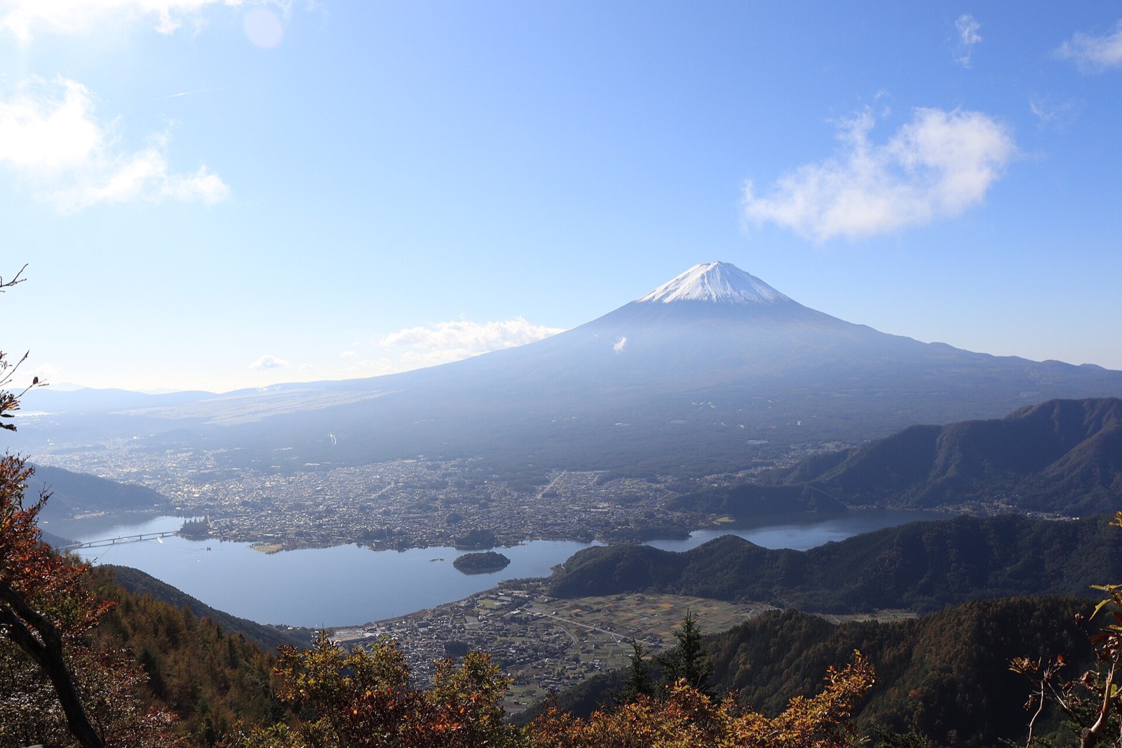 Mount Fuji without snow in summer seen from Shindo Pass above Lake Kawaguchi, with green slopes and blue sky