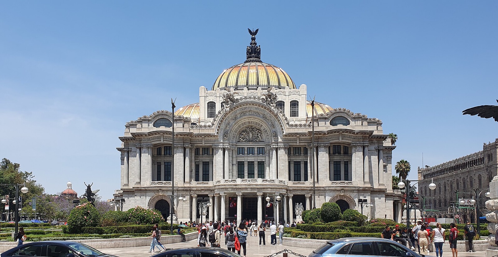 The main facade of the Palacio de Bellas Artes in Mexico City under a clear blue sky
