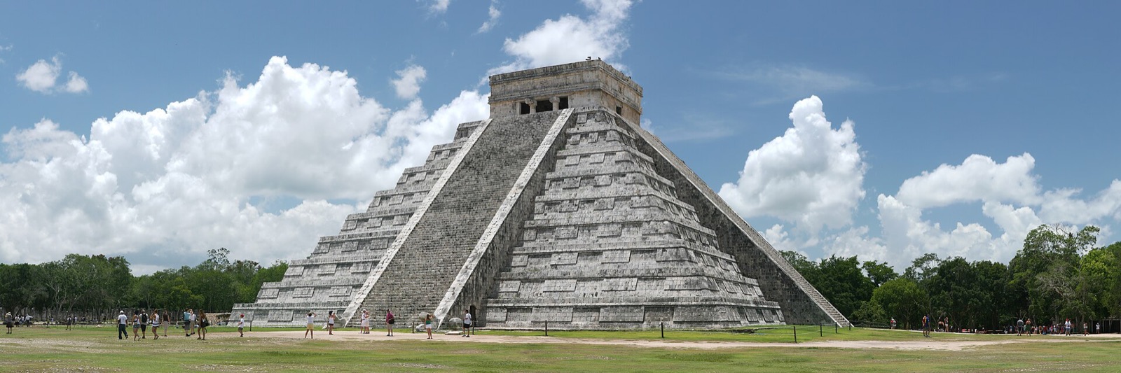 The Temple of Kukulcan, the step pyramid at Chichen Itza in Yucatan, seen across open grass