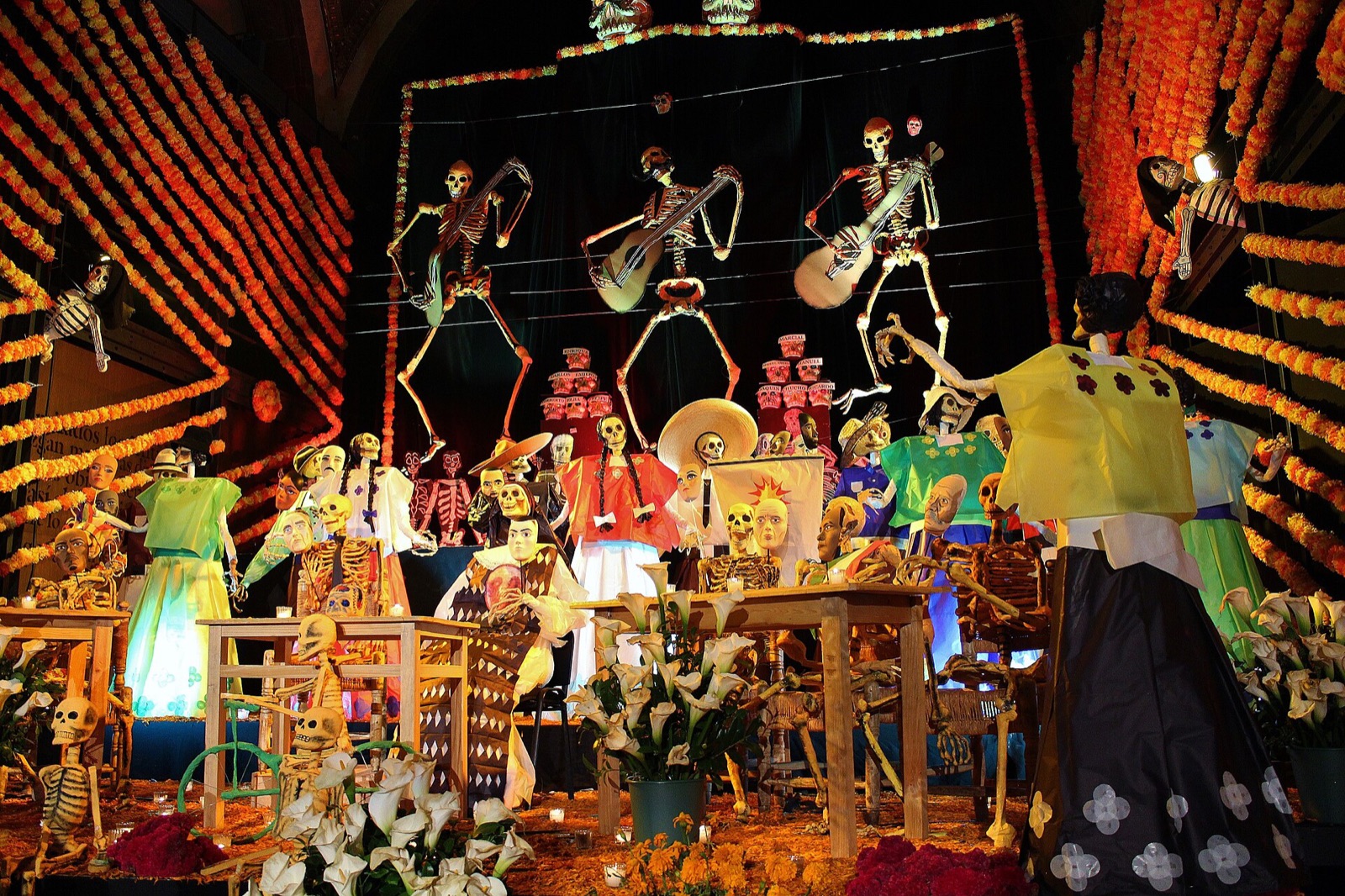 A large Day of the Dead ofrenda altar in Mexico decorated with marigolds, candles and sugar skulls