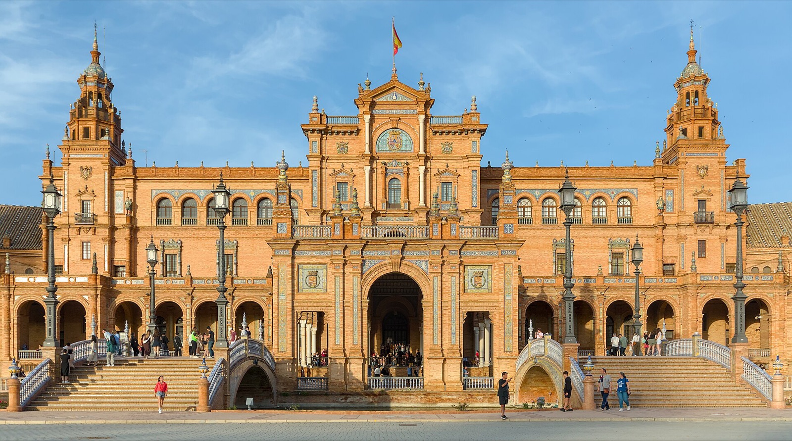 The Plaza de Espana in Seville, its curved brick arcade and canal seen in full sunlight